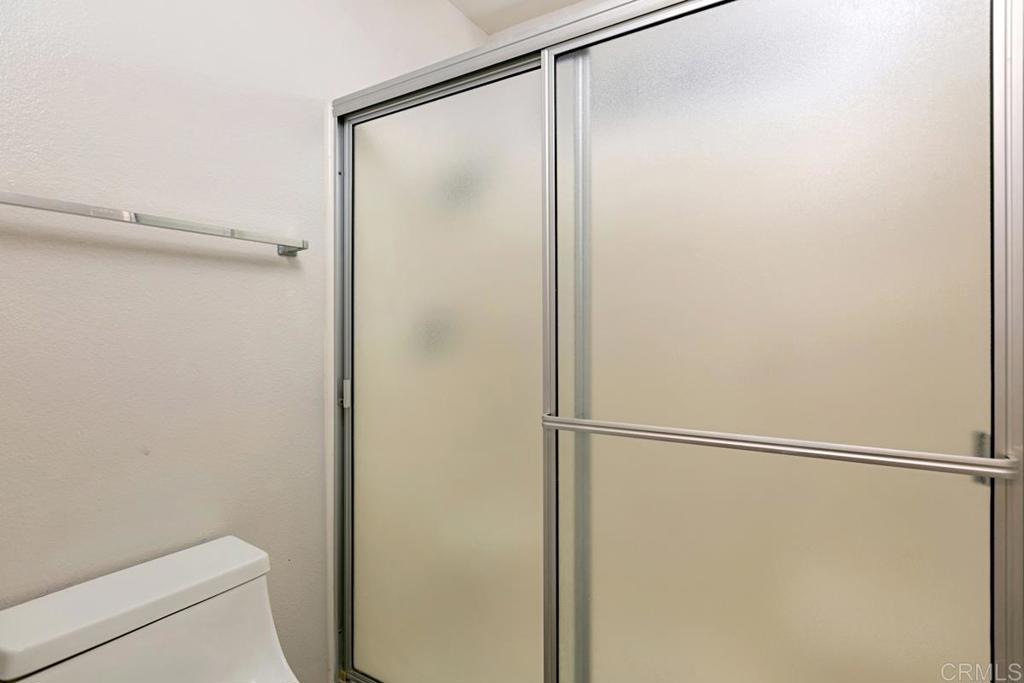 4616 Arrowhead Court Oceanside, CA 92056 - Photo 34 of 50 a bathroom with a glass shower door