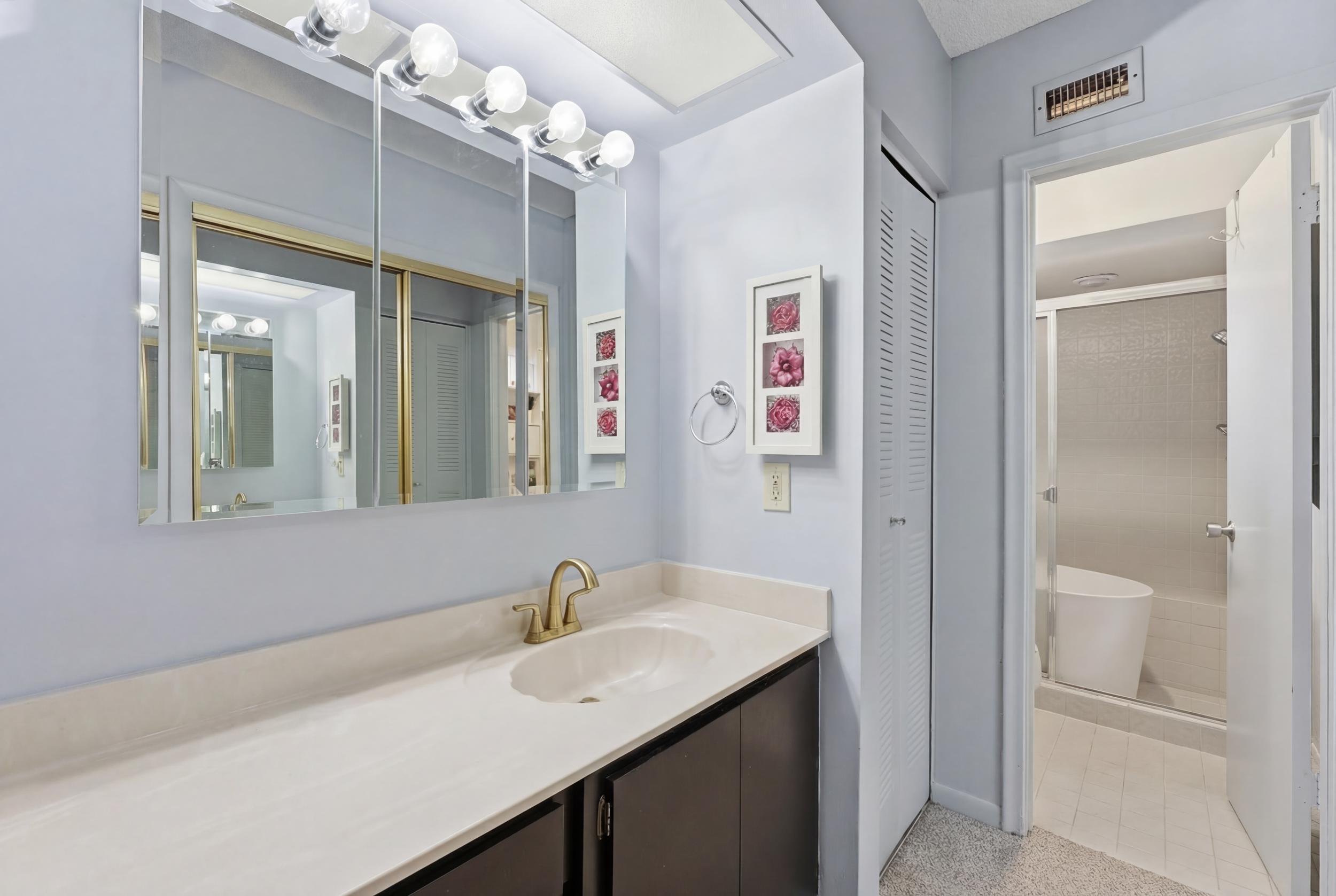 10768 Waterberry Drive Boca Raton, FL 33498 - Photo 12 of 26 a bathroom with a sink vanity granite tub and shower