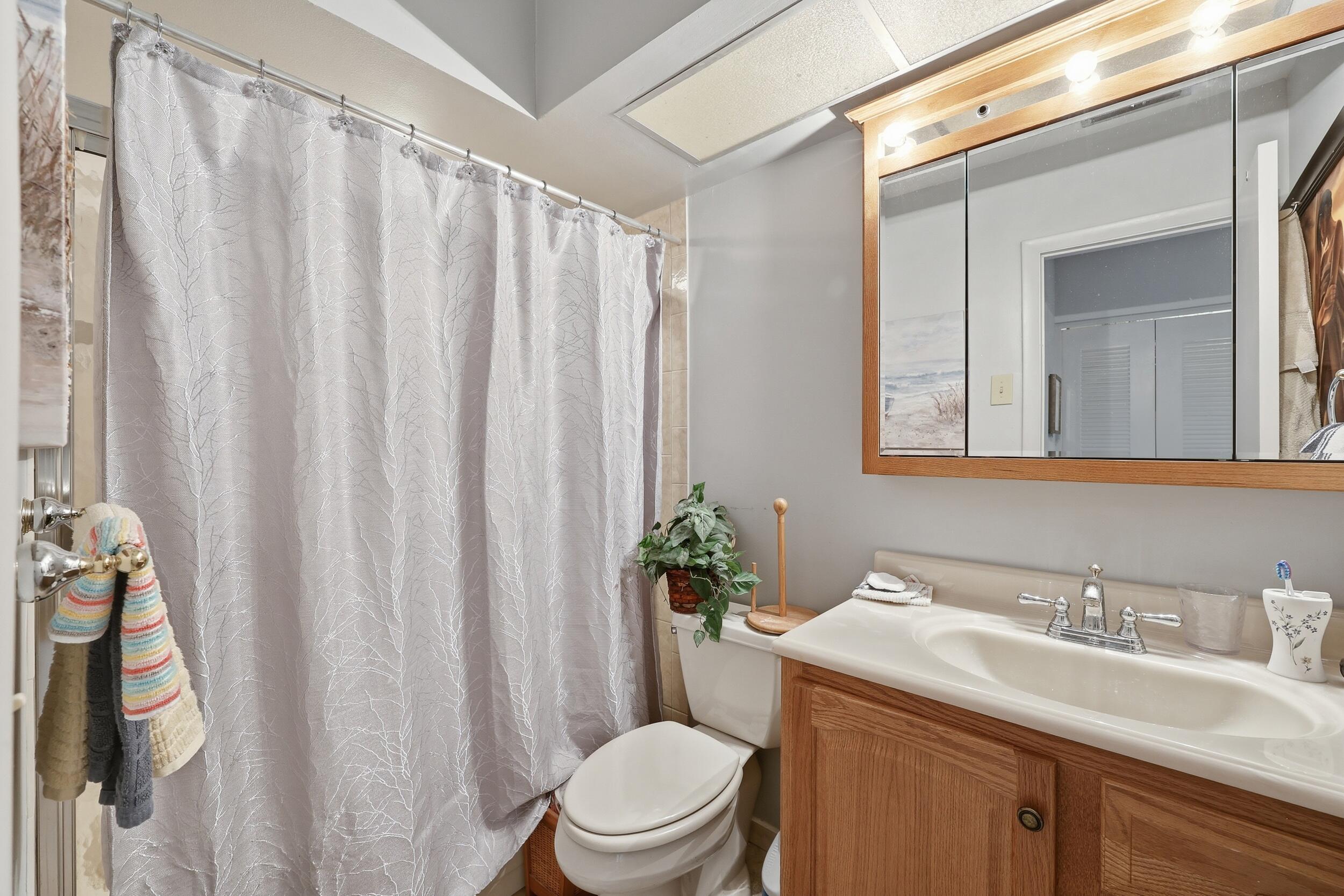 10768 Waterberry Drive Boca Raton, FL 33498 - Photo 16 of 26 a bathroom with a granite countertop sink and a mirror
