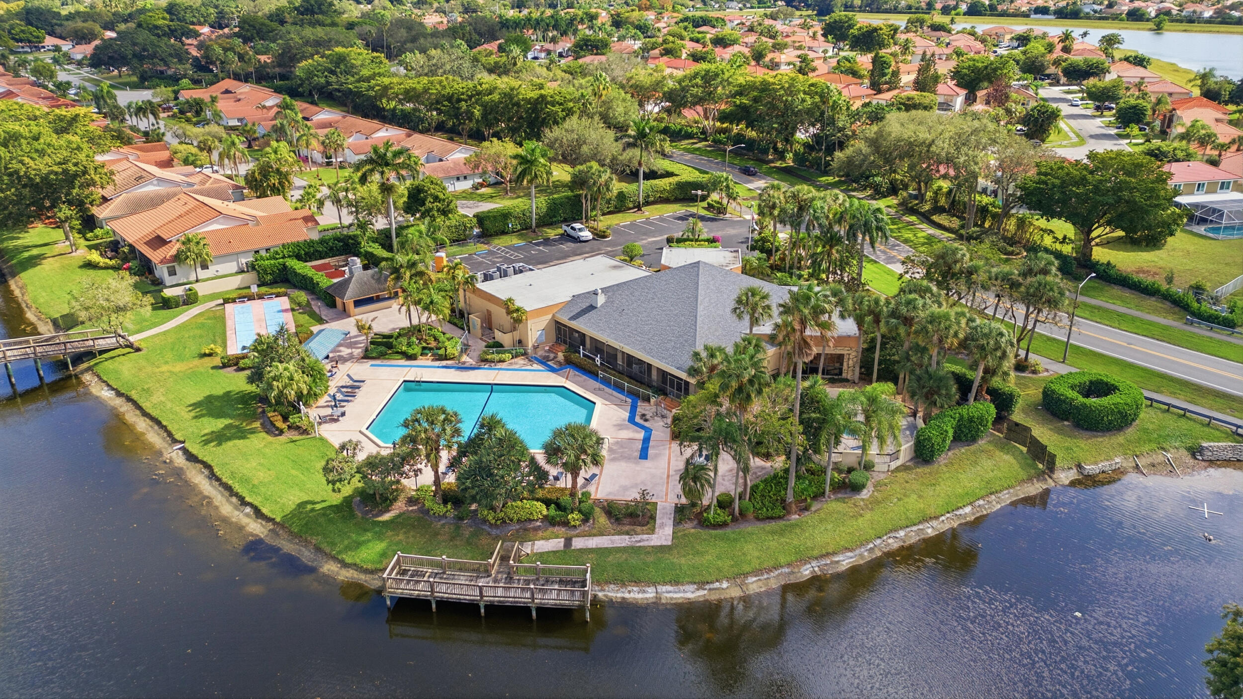 10768 Waterberry Drive Boca Raton, FL 33498 - Photo 24 of 26 an aerial view of a house with a garden and lake view