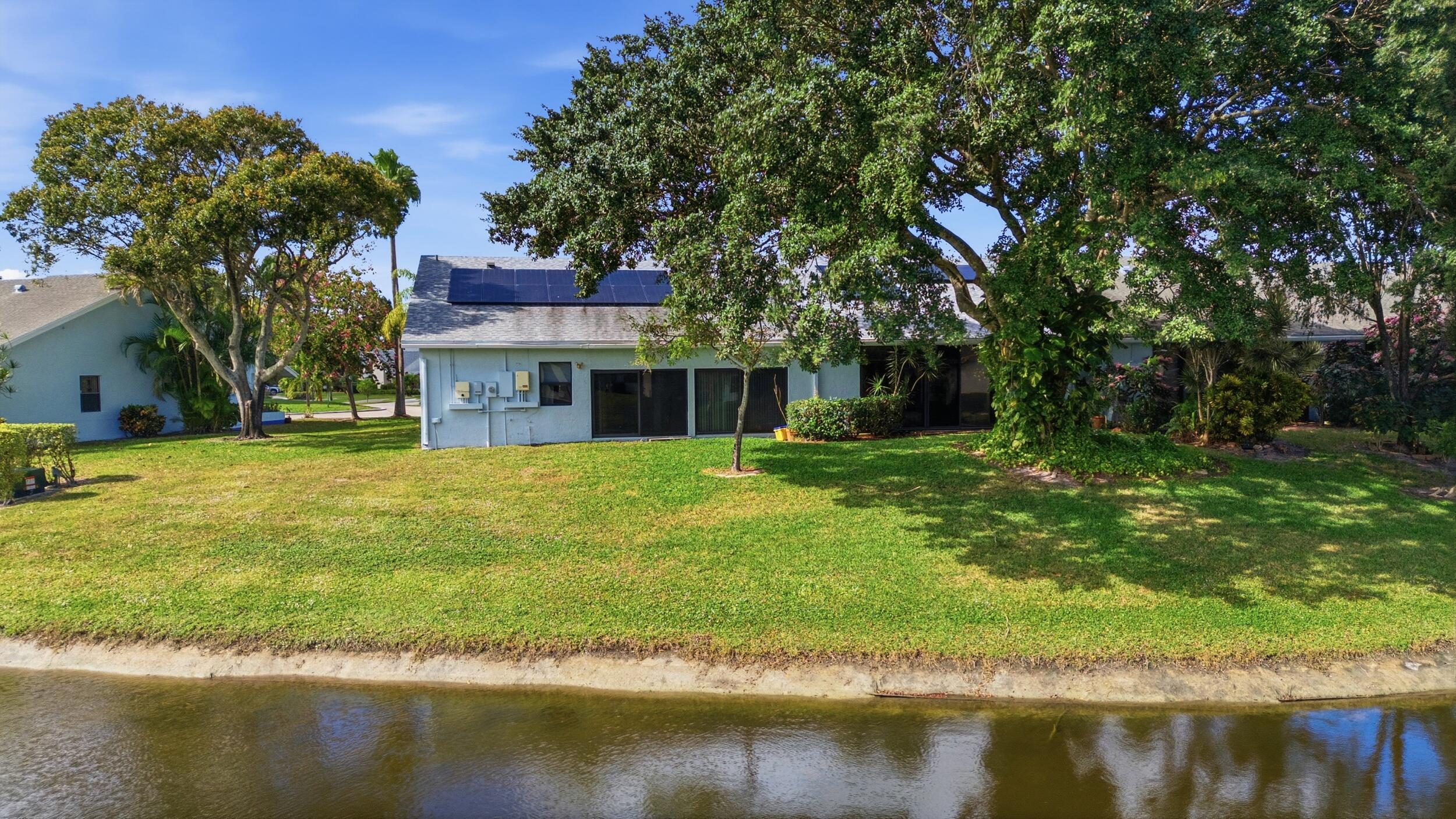 10768 Waterberry Drive Boca Raton, FL 33498 - Photo 25 of 26 a front view of a house with a yard