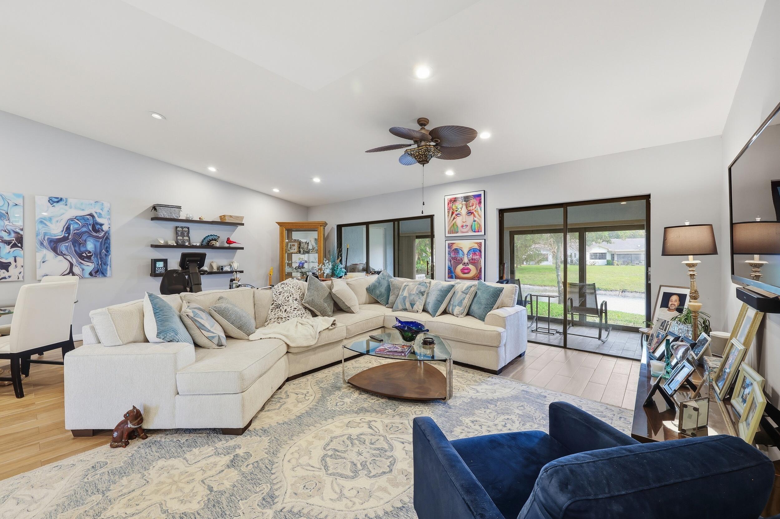 10768 Waterberry Drive Boca Raton, FL 33498 - Photo 5 of 26 a living room with furniture and a large window