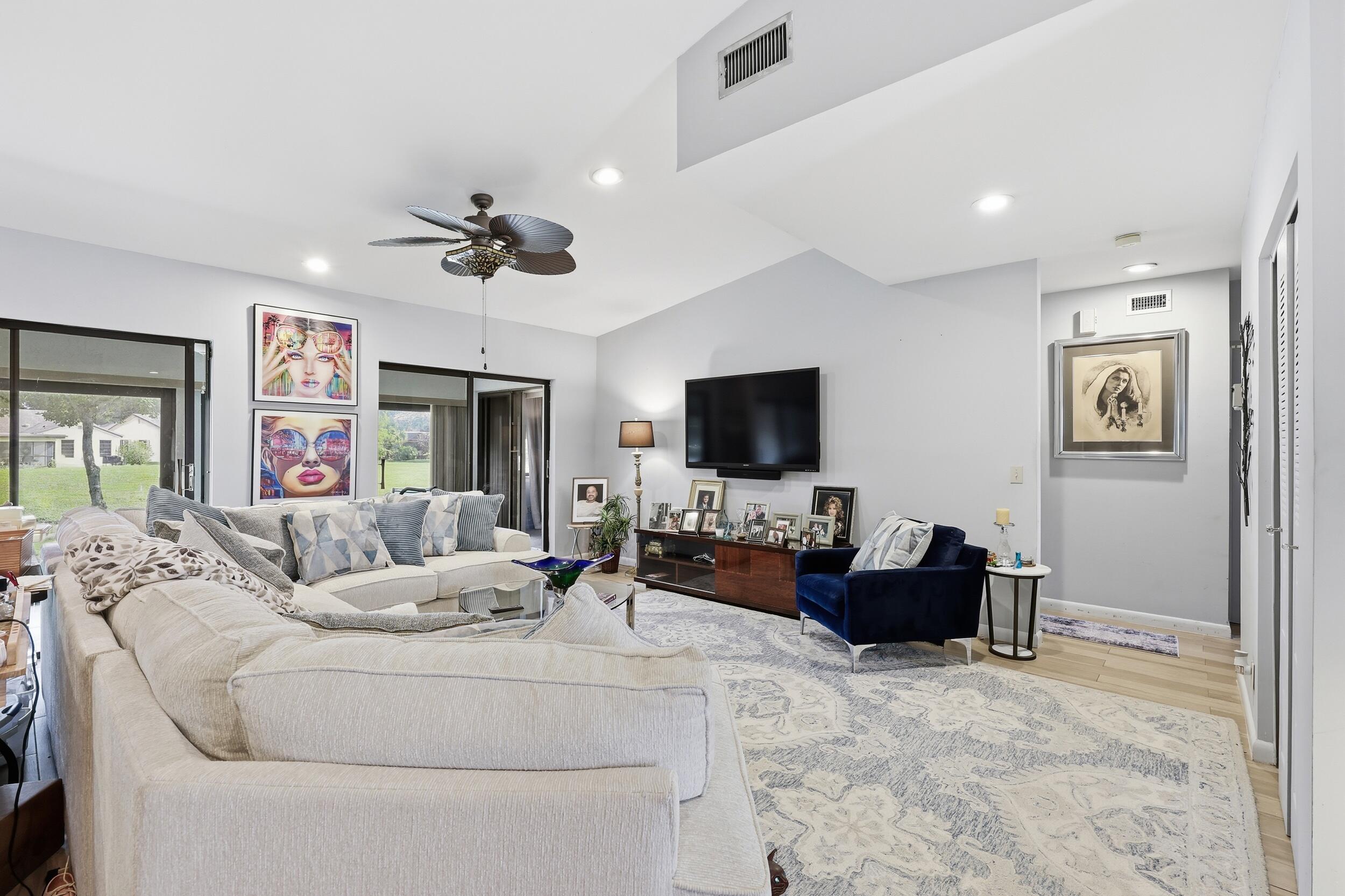 10768 Waterberry Drive Boca Raton, FL 33498 - Photo 6 of 26 a living room with furniture and a flat screen tv
