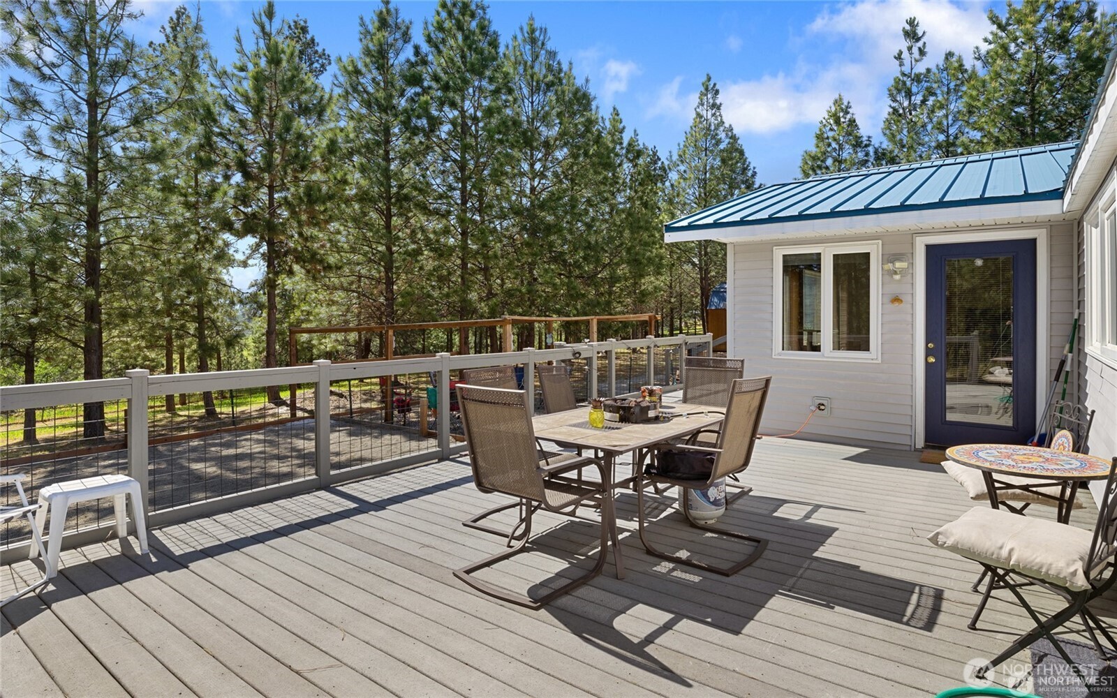 250 Danko Road Cle Elum, WA 98922 - Photo 16 of 38 a view of a roof deck with table and chairs and wooden floor