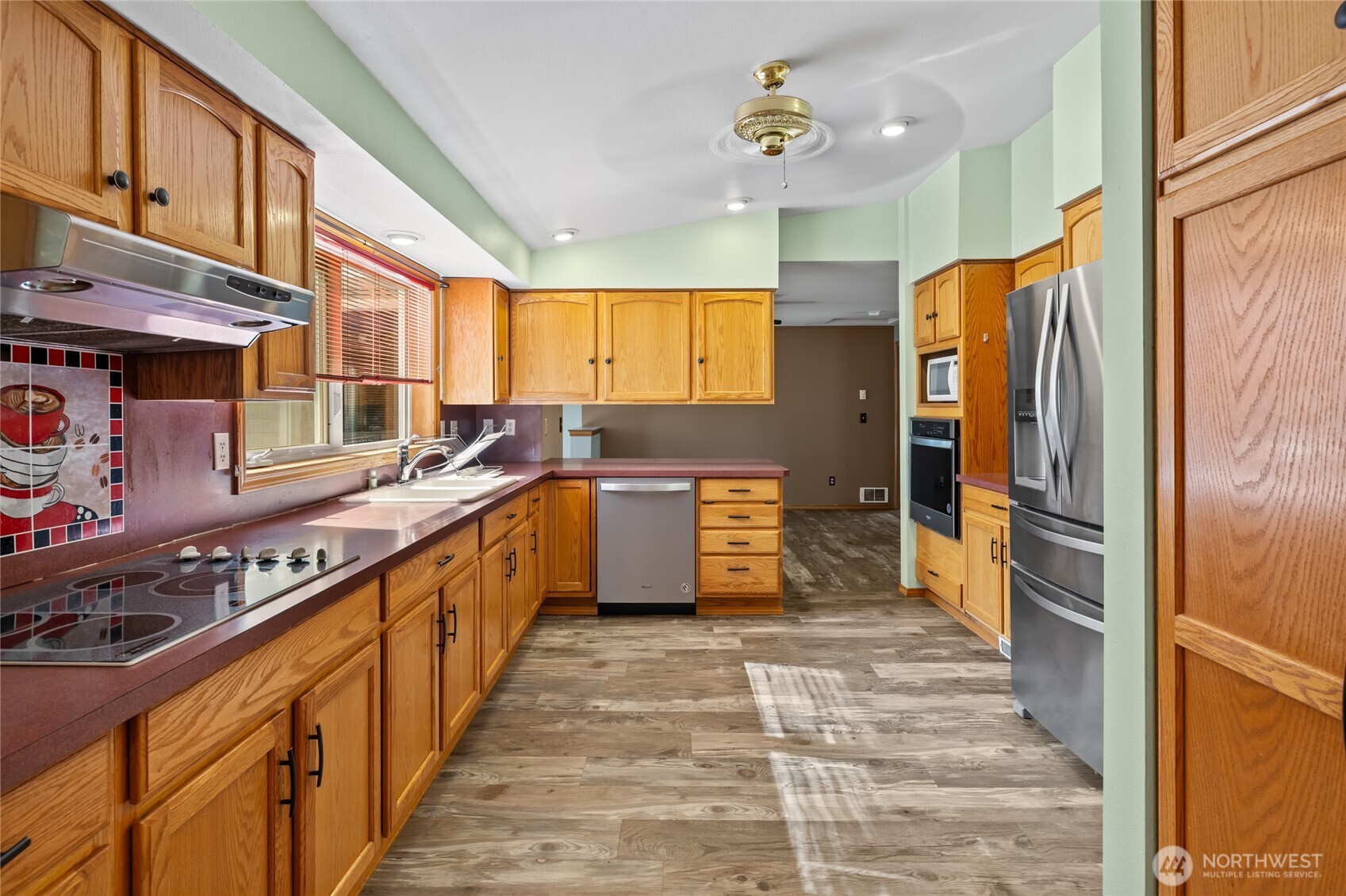 250 Danko Road Cle Elum, WA 98922 - Photo 24 of 38 a kitchen with stainless steel appliances a refrigerator a sink and wooden cabinets