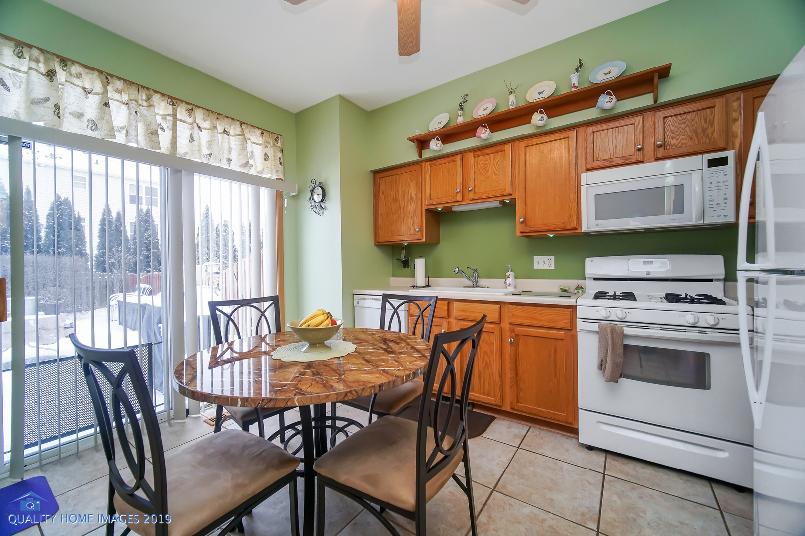 339 Reston Circle Romeoville, IL 60446 - Photo 13 of 26 a kitchen with stainless steel appliances a stove a sink and a dining table