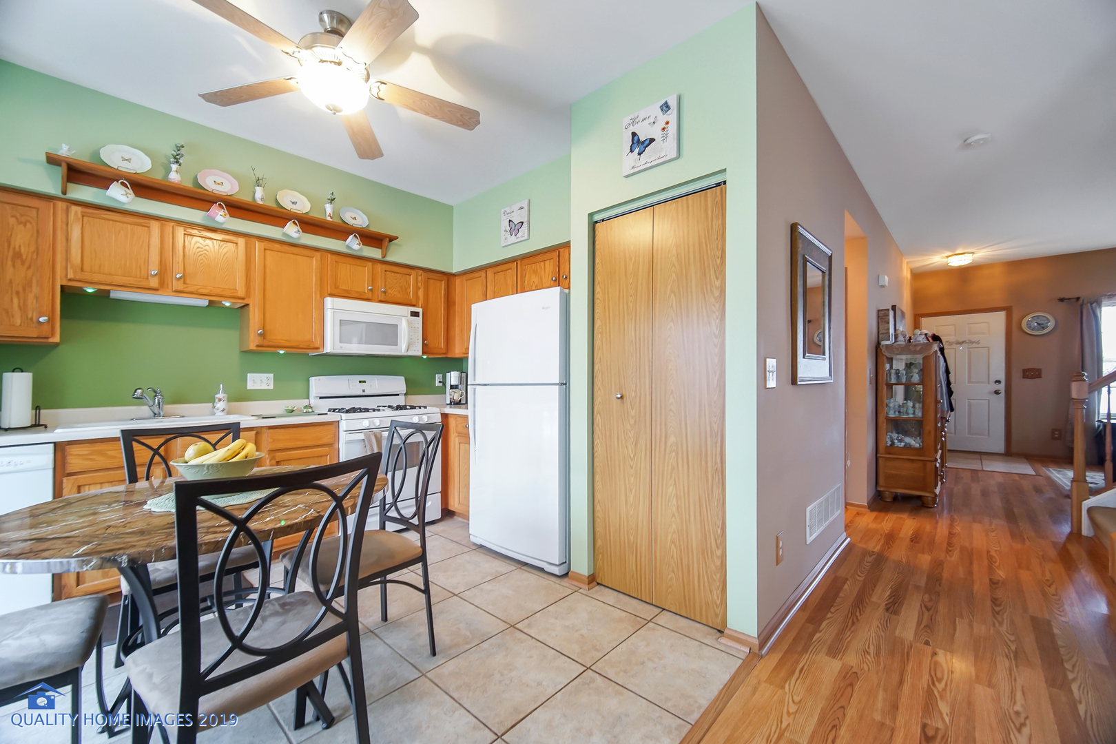 339 Reston Circle Romeoville, IL 60446 - Photo 16 of 26 a open kitchen with stainless steel appliances granite countertop a refrigerator a oven a sink with a dining table and chairs