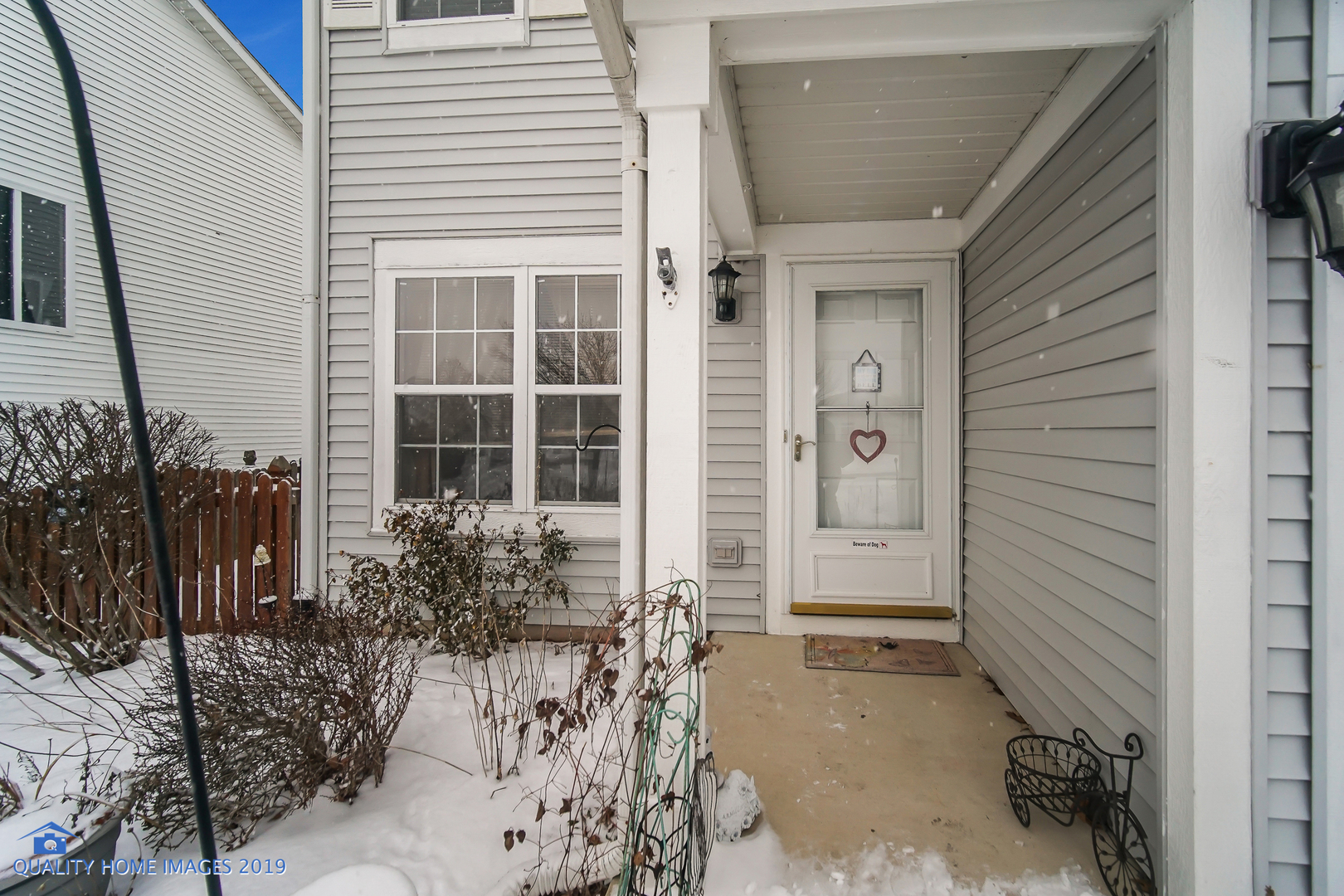 339 Reston Circle Romeoville, IL 60446 - Photo 3 of 26 a house with potted plants in front of door