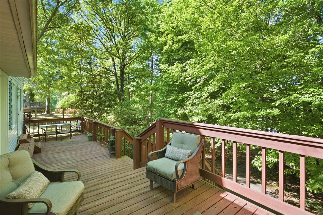 110 Snug Harbor Road Seneca, SC 29678 - Photo 24 of 37 This spacious wooden deck offers abundant natural light and tranquil tree views, perfect for relaxation.