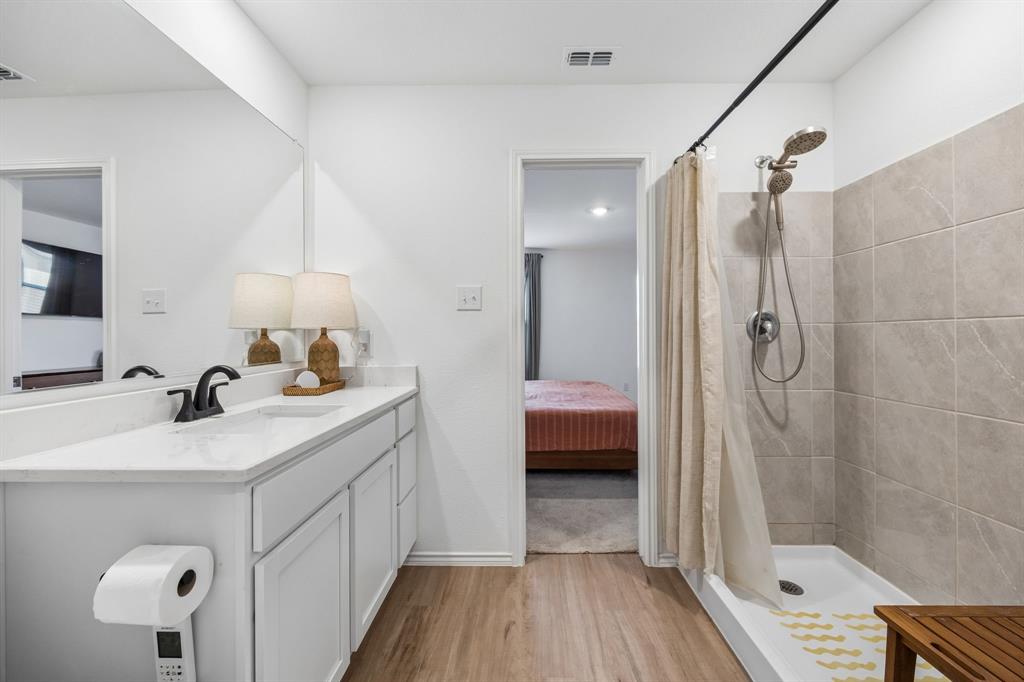 1025 Mountain Laurel Road Princeton, TX 75407 - Photo 13 of 30 a en suite bathroom with a double vanity sink a mirror and shower