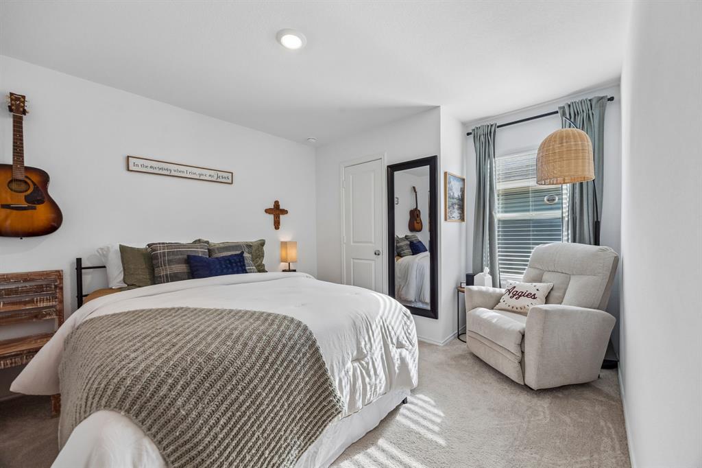 1025 Mountain Laurel Road Princeton, TX 75407 - Photo 17 of 30 a bedroom with bed and a couch