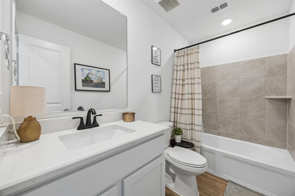 1025 Mountain Laurel Road Princeton, TX 75407 - Photo 18 of 30 a bathroom with a sink a toilet and shower
