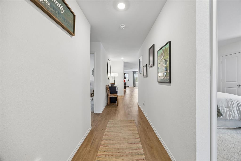 1025 Mountain Laurel Road Princeton, TX 75407 - Photo 2 of 30 a view of a hallway with wooden floor and staircase