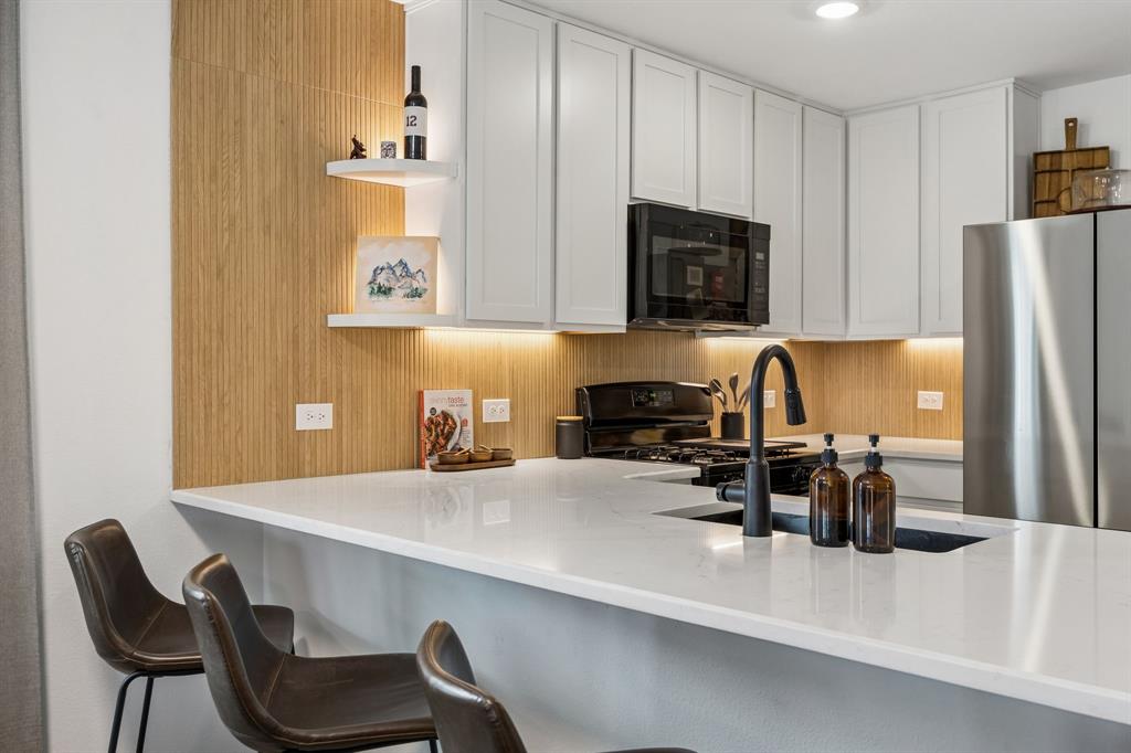 1025 Mountain Laurel Road Princeton, TX 75407 - Photo 6 of 30 a kitchen with a sink cabinets and refrigerator