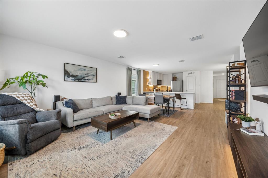 1025 Mountain Laurel Road Princeton, TX 75407 - Photo 7 of 30 a living room with furniture and wooden floor