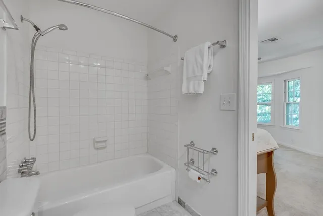 a bathroom with a bathtub and a shower