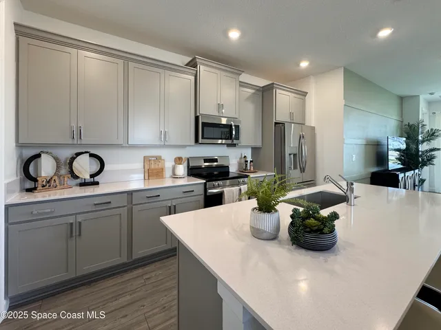 a kitchen with a sink appliances and cabinets