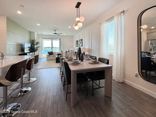 a view of a a dining room with furniture window and wooden floor