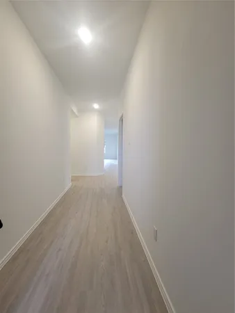 a view of hallway with wooden floor