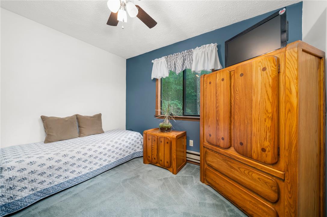 222 Powder Horn Road Henryville, PA 18332 - Photo 17 of 25 A well-lit bedroom features plush carpeting and a large window providing ample natural light.