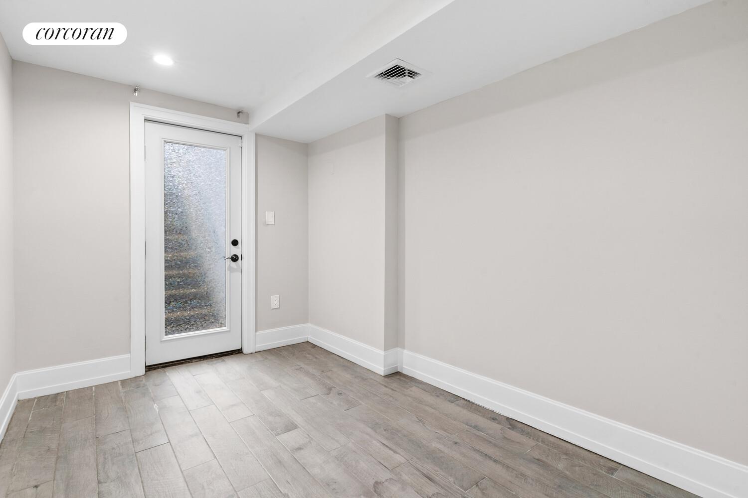 139 Rochester Avenue Brooklyn, NY 11213 - Photo 15 of 17 a view of an empty room with wooden floor and closet