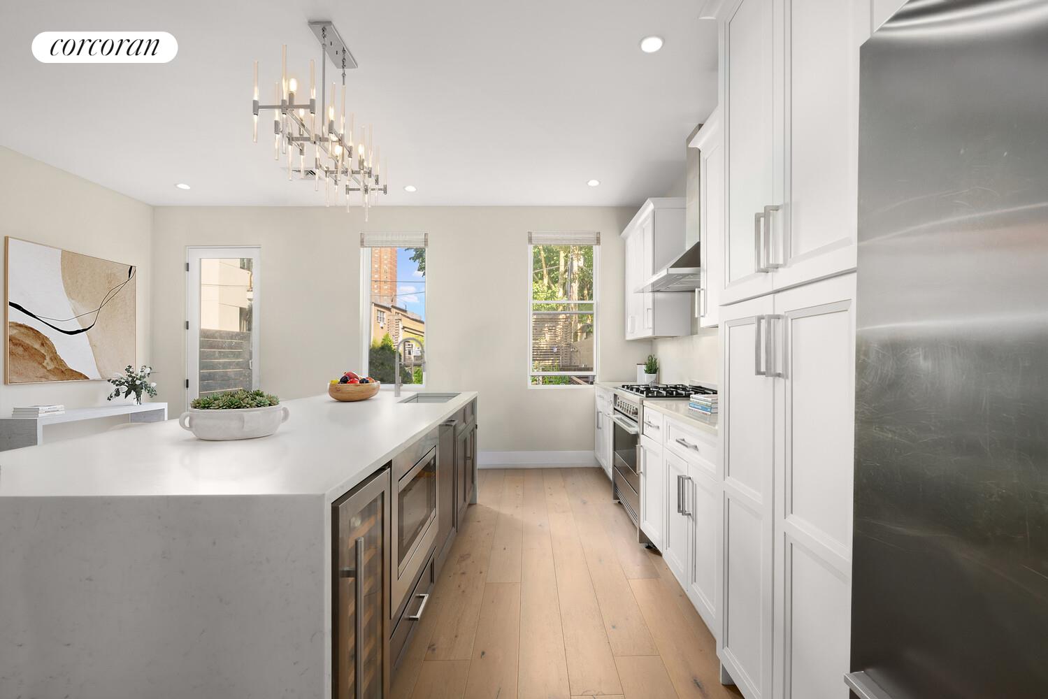 139 Rochester Avenue Brooklyn, NY 11213 - Photo 3 of 17 a kitchen with kitchen island white cabinets and stainless steel appliances