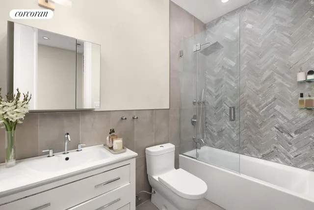 a bathroom with a bathtub a toilet and a shower