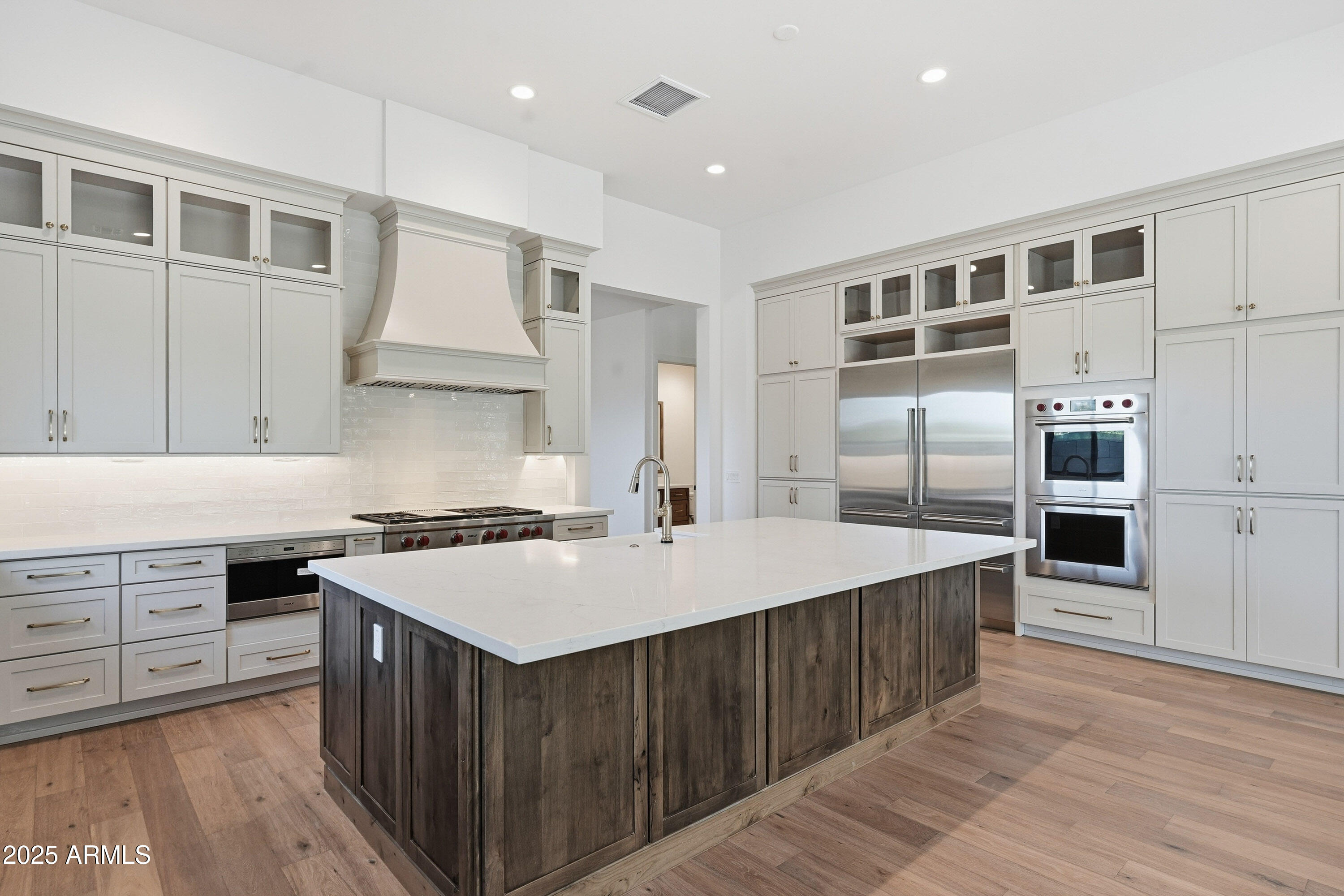 3326 South Stuart Court Gilbert, AZ 85297 - Photo 11 of 88 a kitchen with a stove a sink and a refrigerator