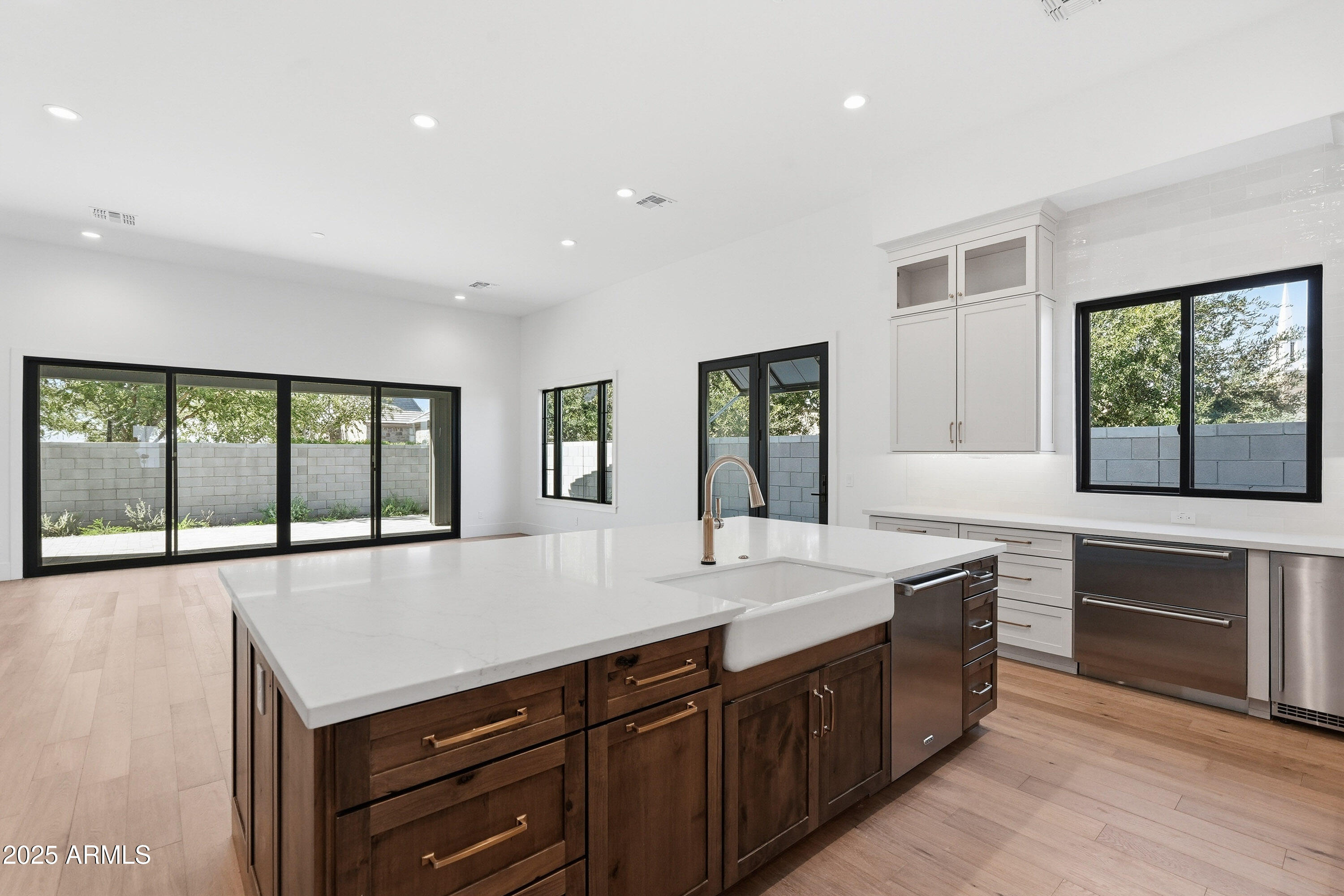 3326 South Stuart Court Gilbert, AZ 85297 - Photo 13 of 88 a large kitchen with kitchen island a large window a sink and stainless steel appliances