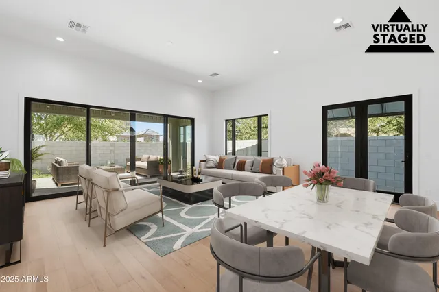 a spacious bathroom with double vanity and mirrors