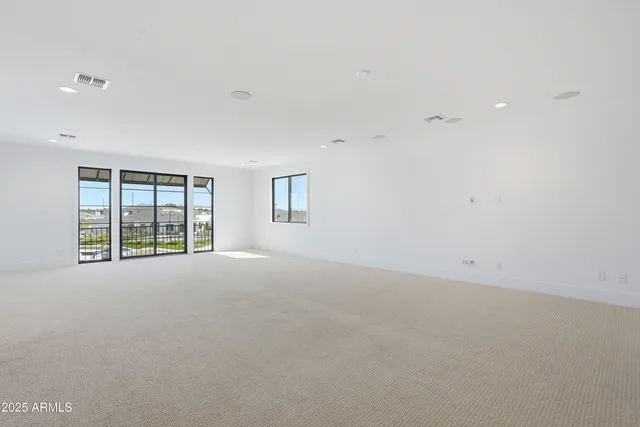 an aerial view of a house with a garden and lake view