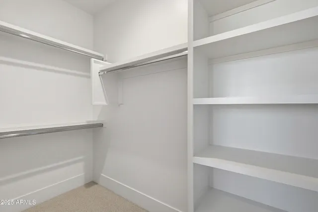 a view of a patio with table and chairs potted plants with floor to ceiling window