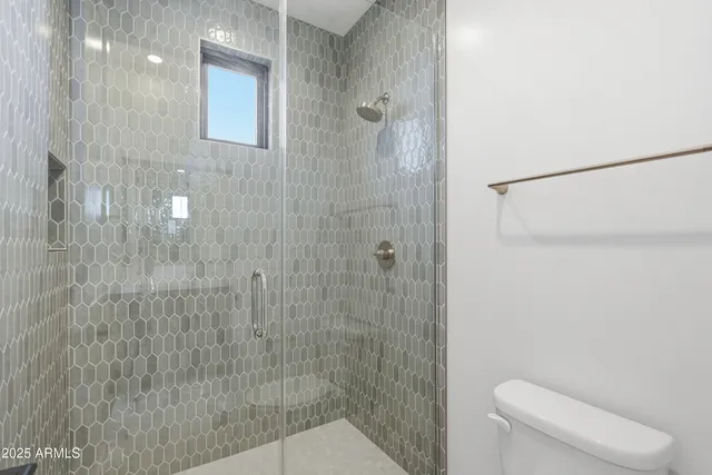 a living room with lots of furniture and a large window