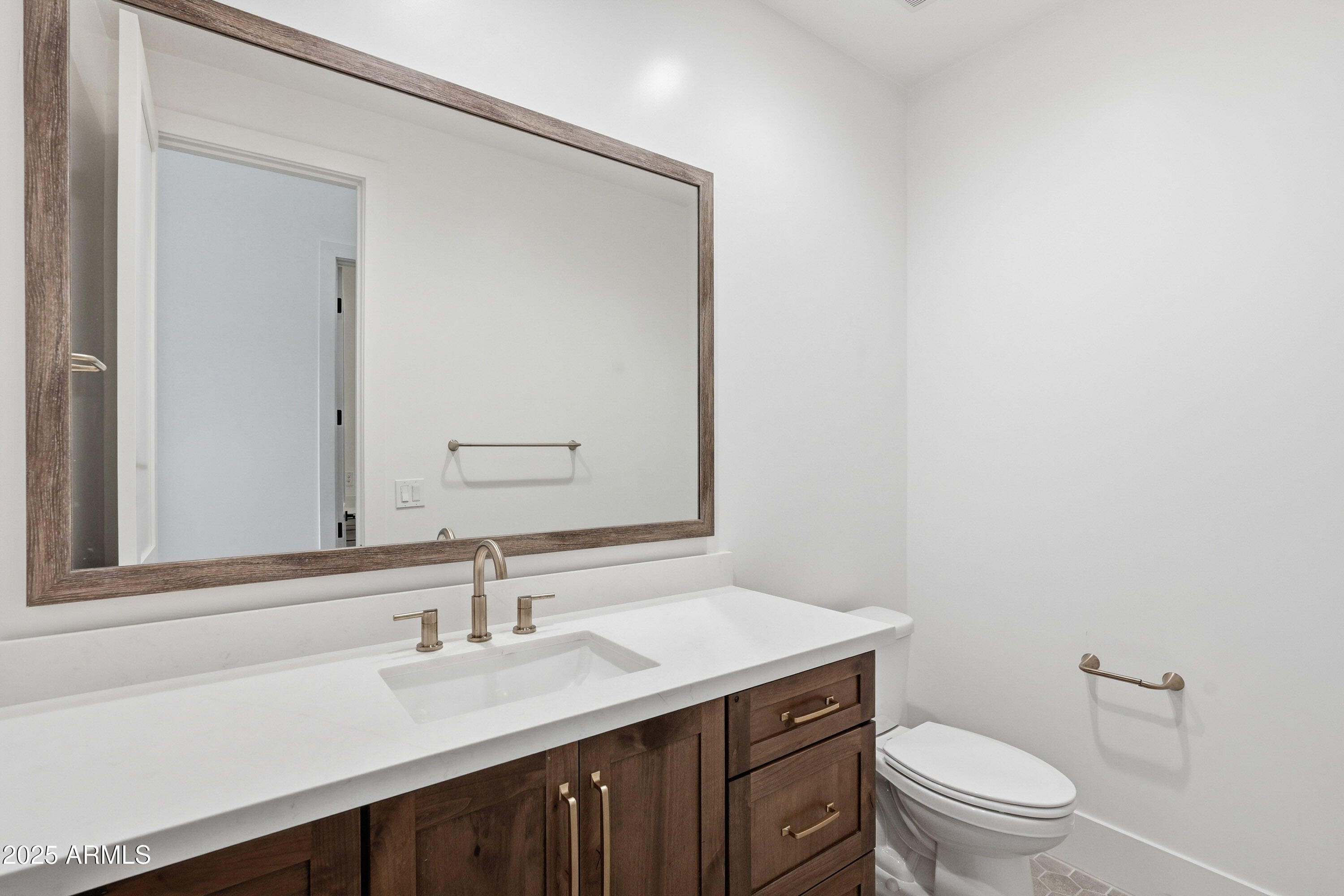 3326 South Stuart Court Gilbert, AZ 85297 - Photo 49 of 88 a bathroom with a granite countertop sink a toilet and a mirror
