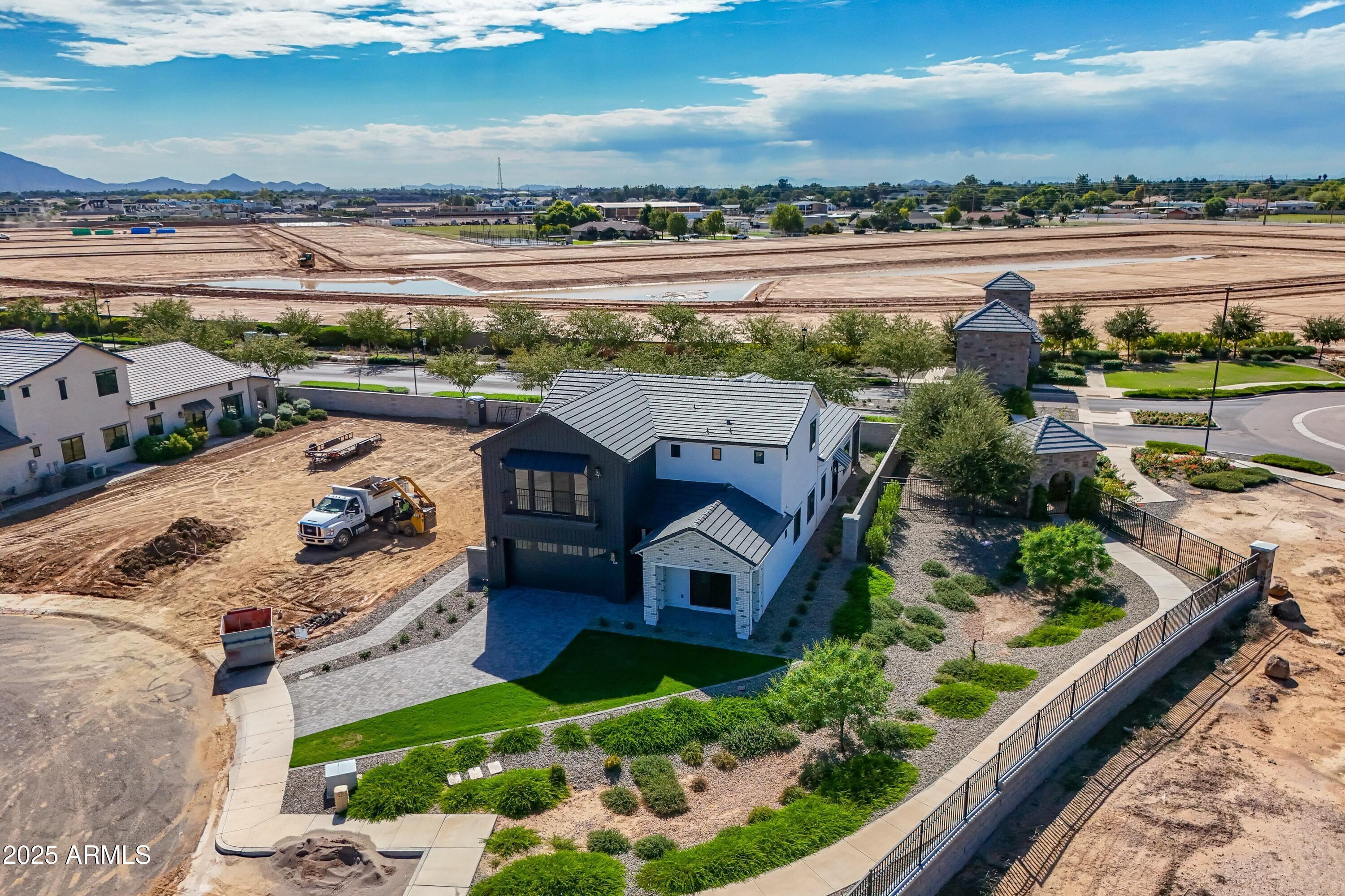 3326 South Stuart Court Gilbert, AZ 85297 - Photo 58 of 88 an aerial view of a house with a garden and lake view