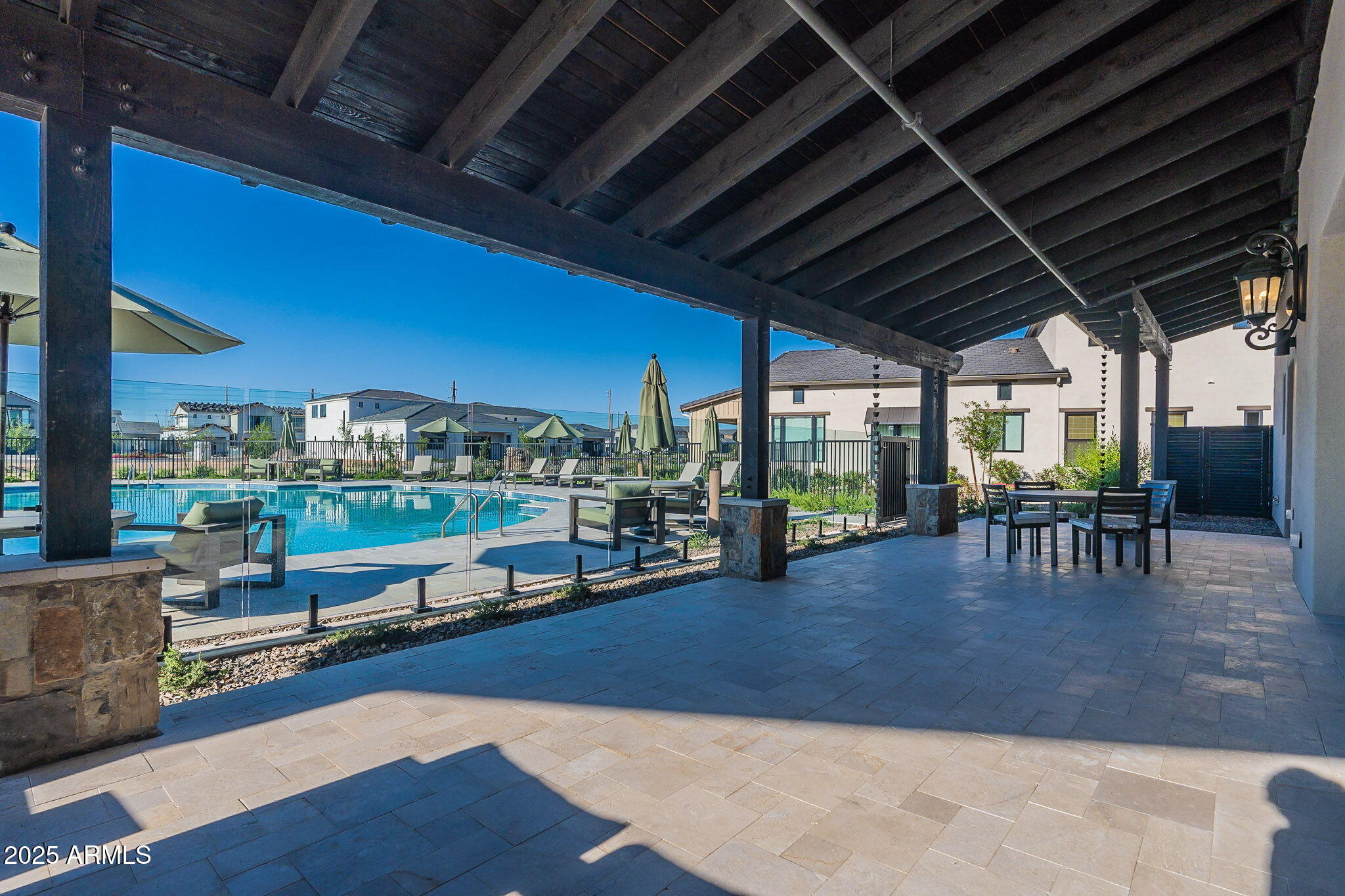 3326 South Stuart Court Gilbert, AZ 85297 - Photo 69 of 88 a view of a patio with table and chairs potted plants with floor to ceiling window