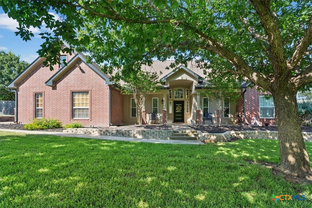 5306 Denmans Loop Belton, TX 76513 - Photo 2 of 46 a front view of a house with a garden and patio