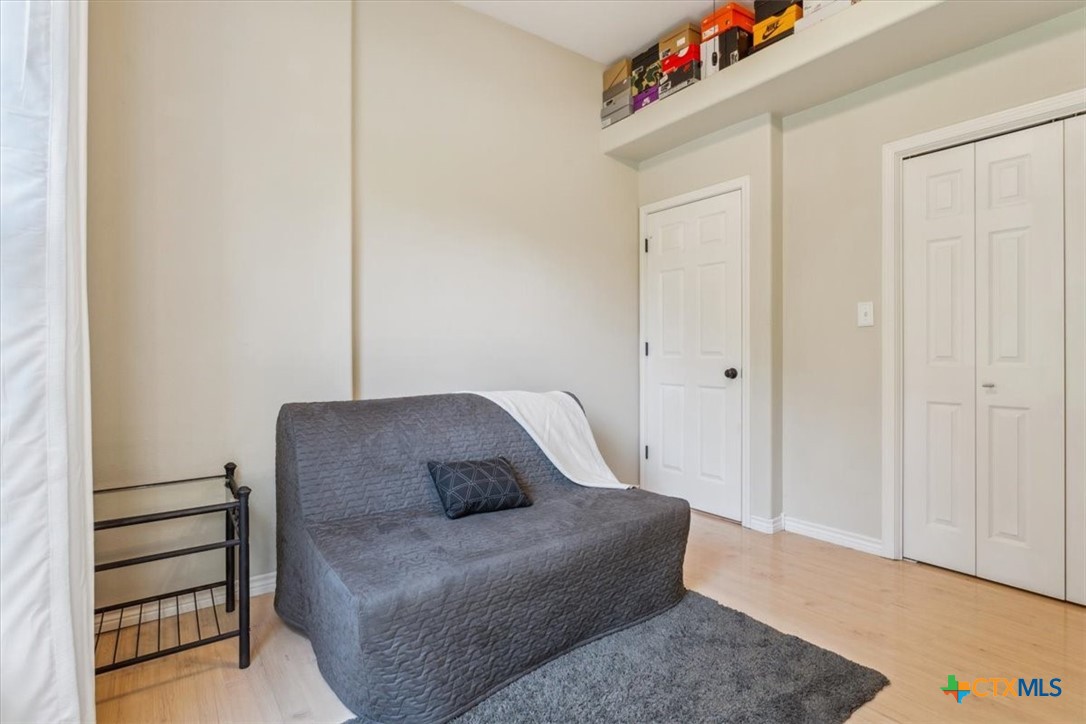 5306 Denmans Loop Belton, TX 76513 - Photo 28 of 46 a living room with a couch and a dresser with wooden floor