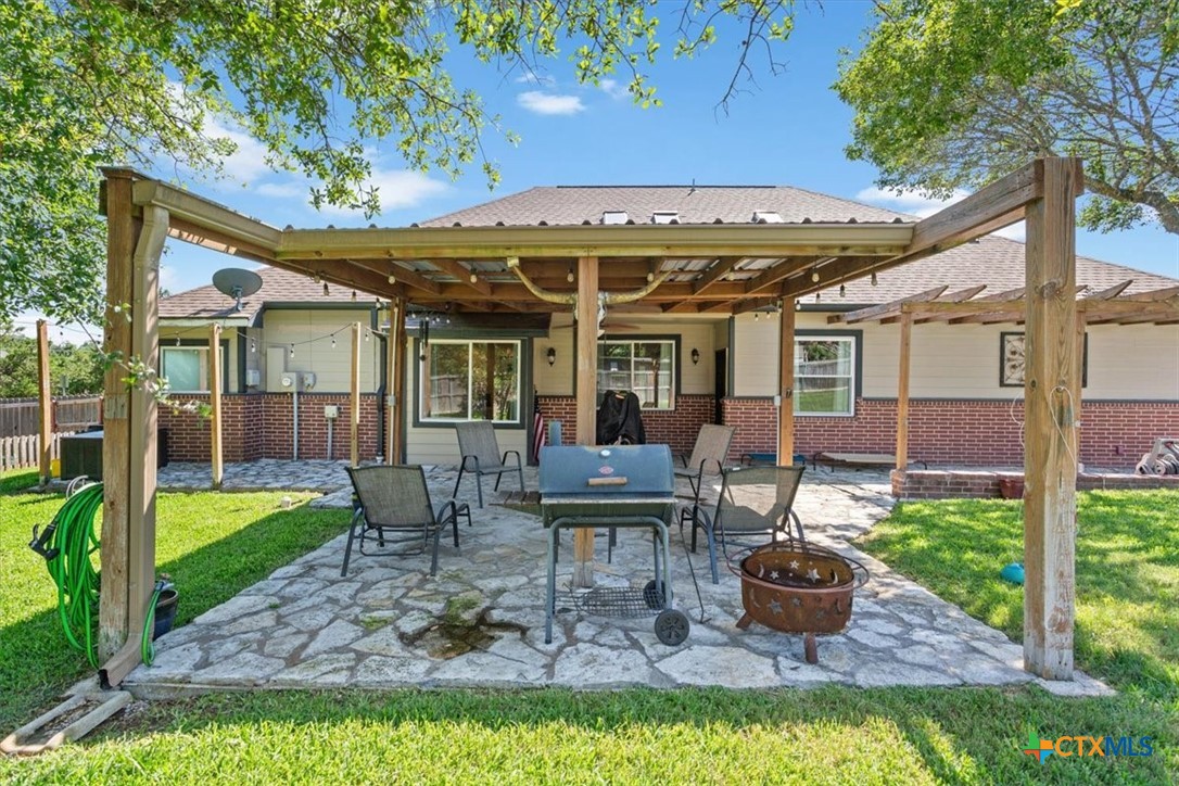 5306 Denmans Loop Belton, TX 76513 - Photo 34 of 46 a view of a patio with table and chairs potted plants and large tree