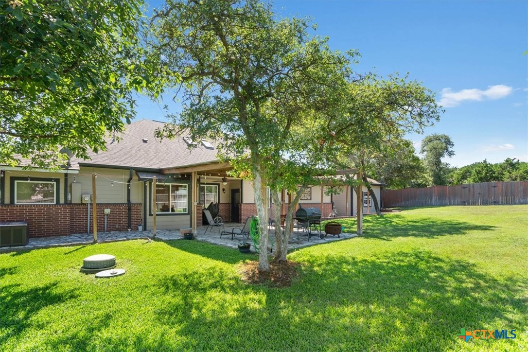 5306 Denmans Loop Belton, TX 76513 - Photo 37 of 46 a view of a yard with a table and chairs under an umbrella