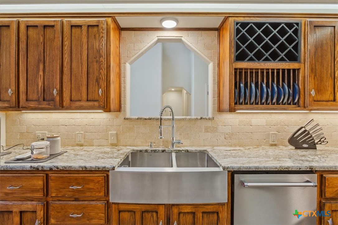 5306 Denmans Loop Belton, TX 76513 - Photo 9 of 46 a kitchen with granite countertop a sink and cabinets