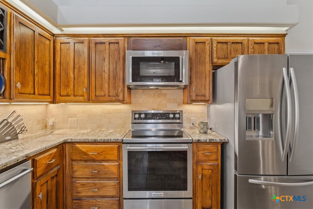 5306 Denmans Loop Belton, TX 76513 - Photo 10 of 46 a kitchen with stainless steel appliances granite countertop a refrigerator and a sink