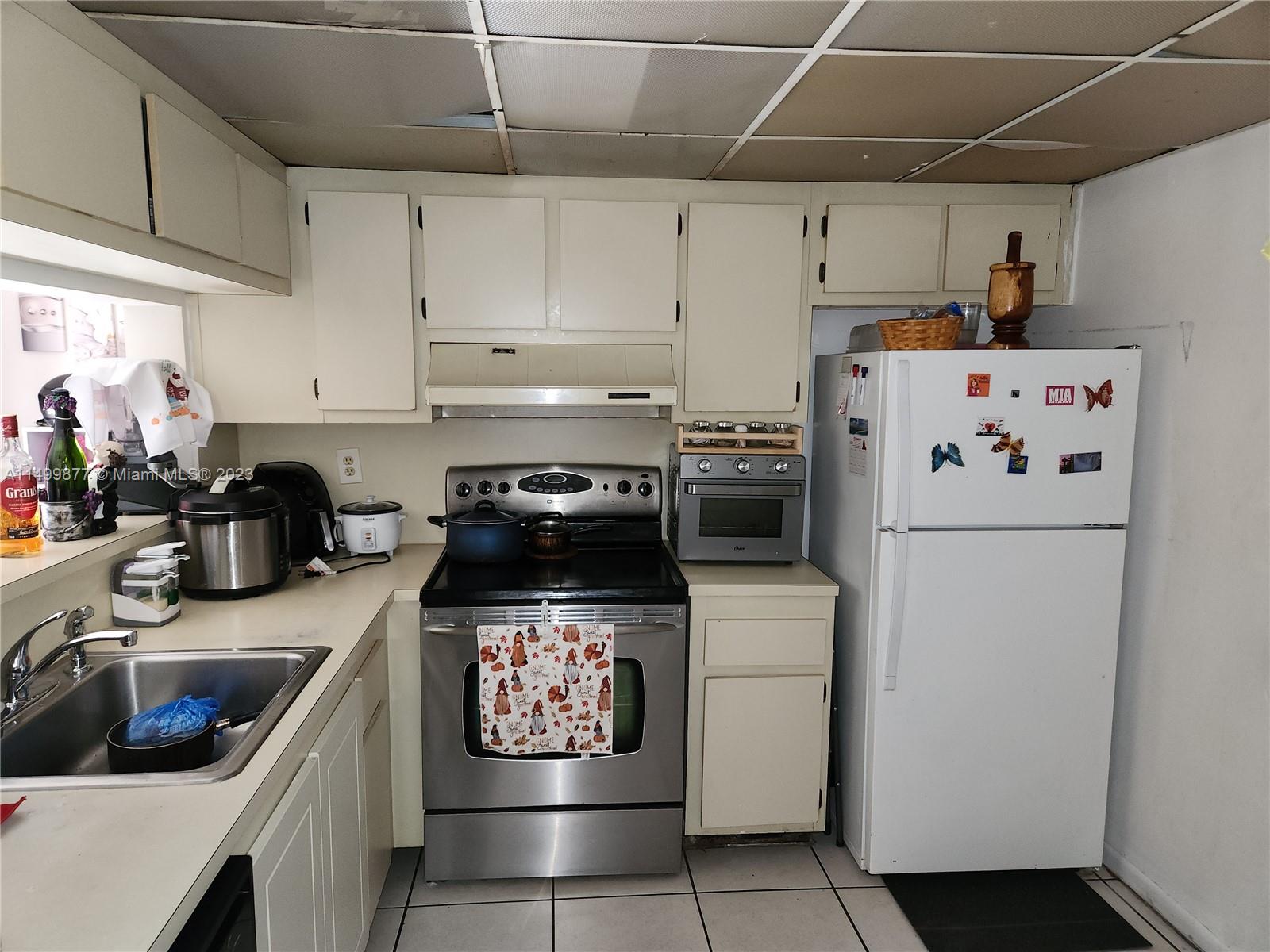 3601 Southwest 117th Avenue, Unit 9104 Miami, FL 33165 - Photo 2 of 9 a kitchen with stainless steel appliances a stove a sink and white cabinets