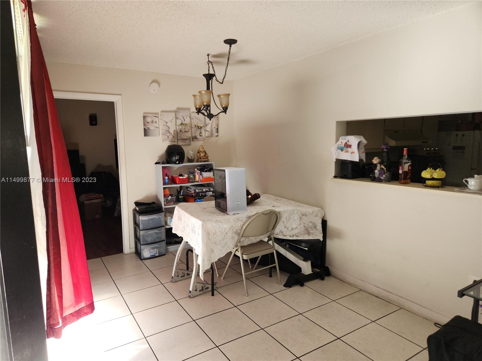 3601 Southwest 117th Avenue, Unit 9104 Miami, FL 33165 - Photo 4 of 9 a living room with furniture and a flat screen tv