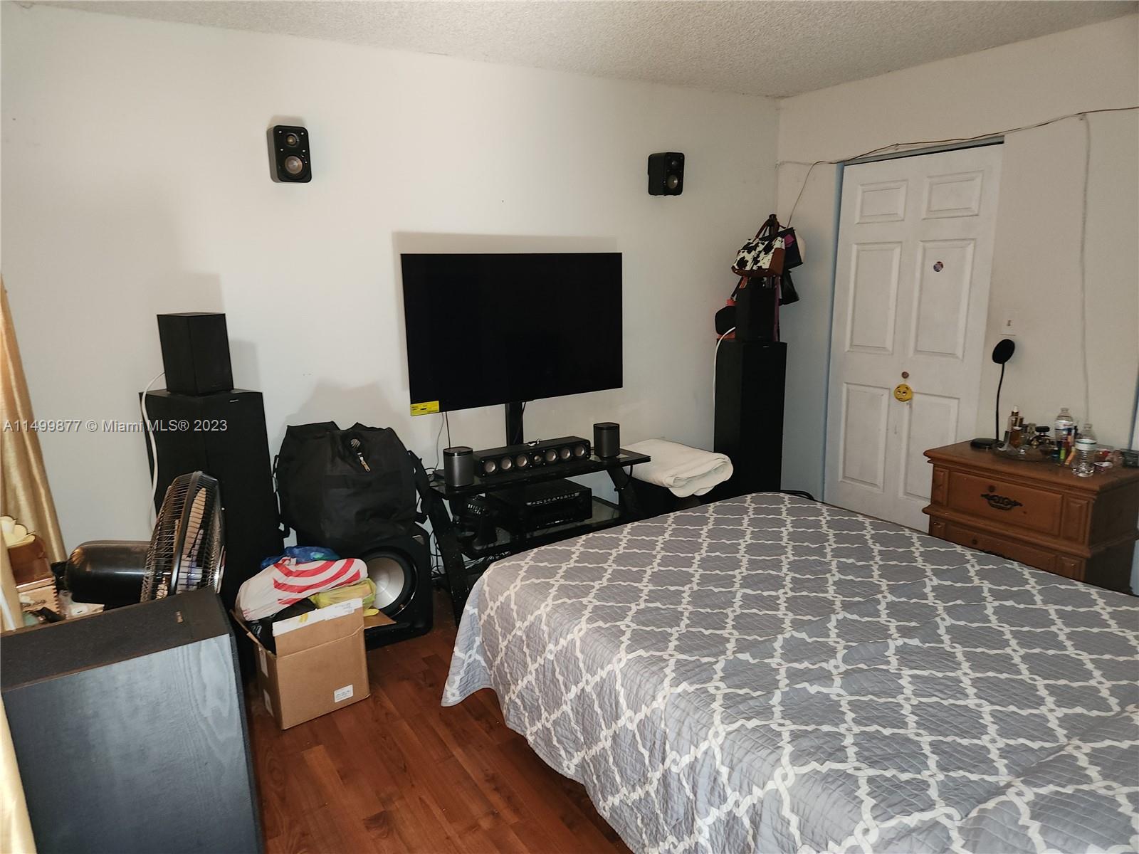3601 Southwest 117th Avenue, Unit 9104 Miami, FL 33165 - Photo 6 of 9 a bedroom with a bed and a flat screen tv