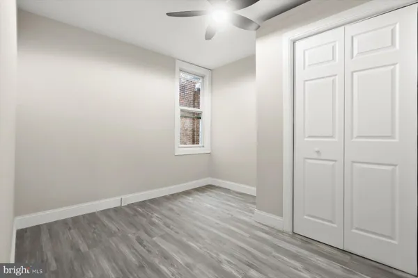 an empty room with windows and closet