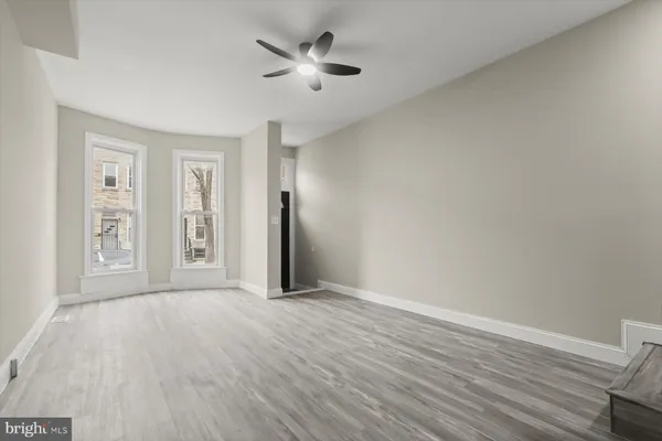 wooden floor in an empty room with a window