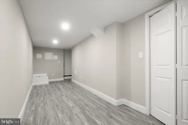 a view of an empty room and wooden floor