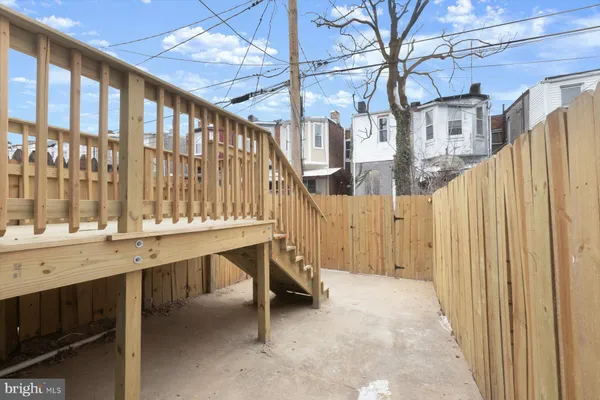 a view of a house with a wooden fence