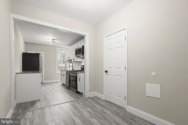 a view of a kitchen with a sink and a refrigerator